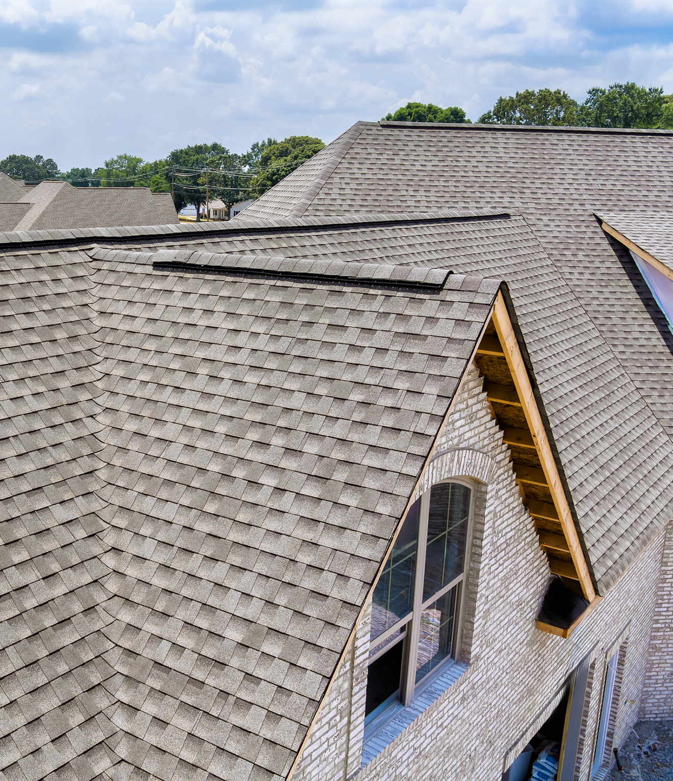 House with gray shingled roof and windows.