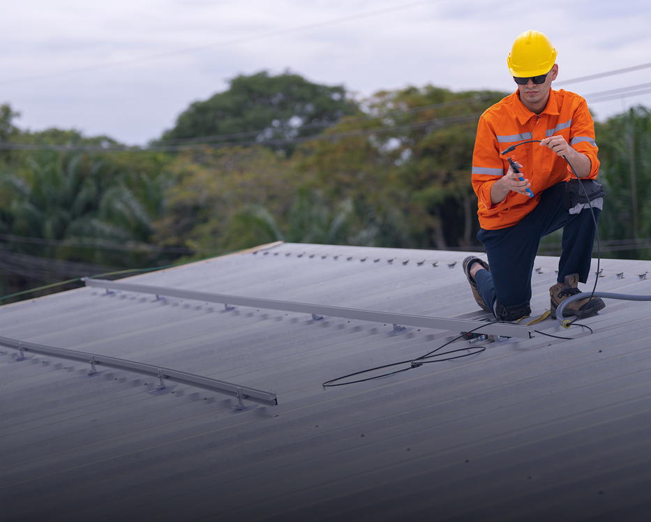 Worker inspecting rooftop with safety gear.