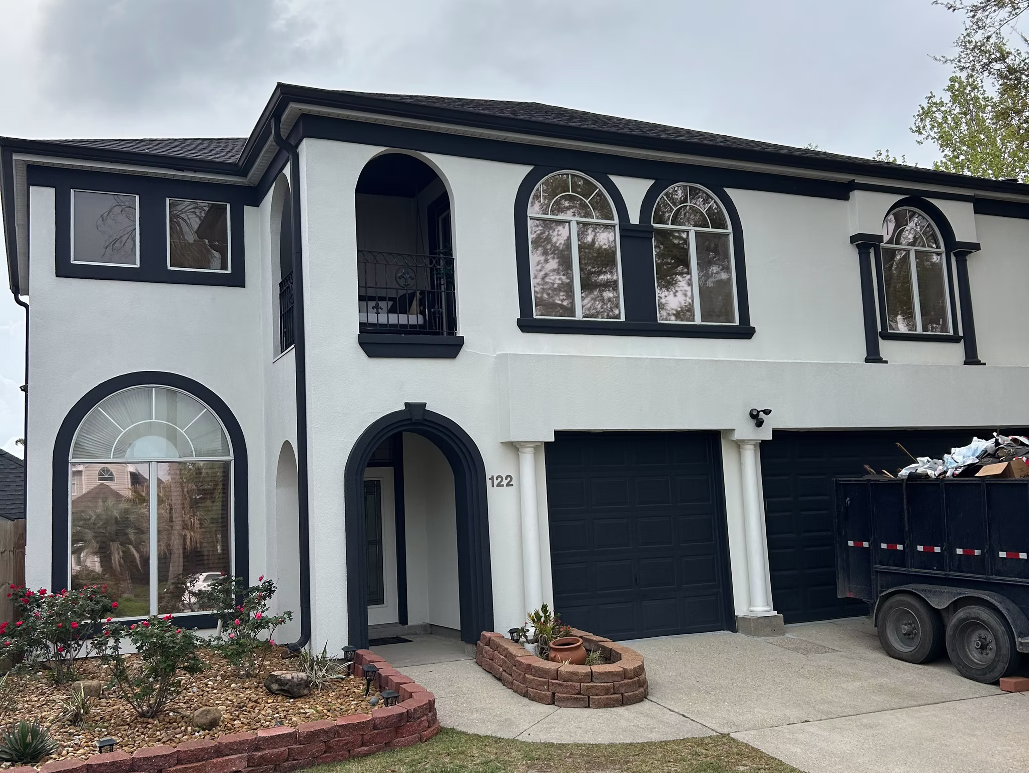 White two-story house with black trim.
