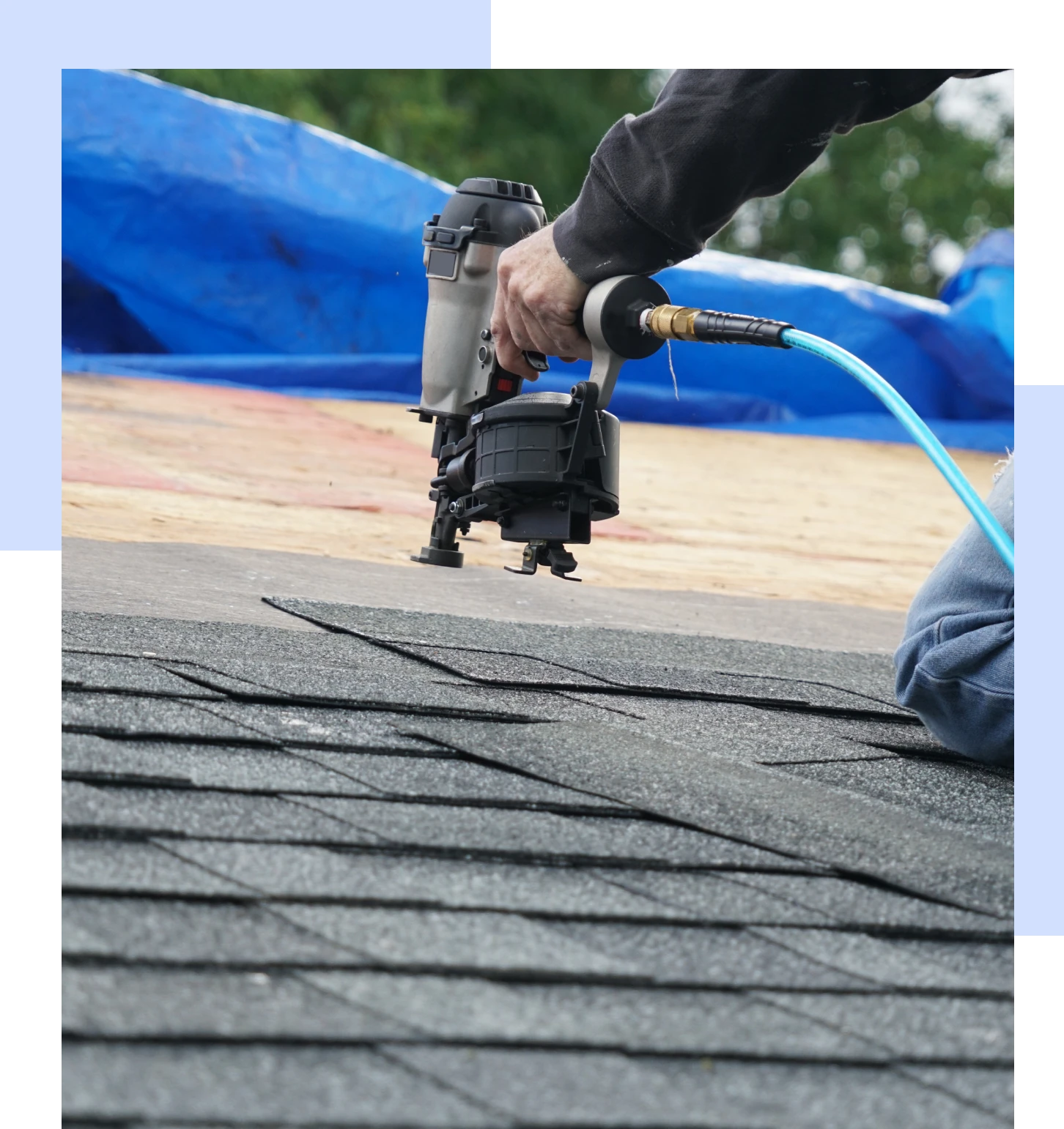 Roofer using nail gun on shingles.