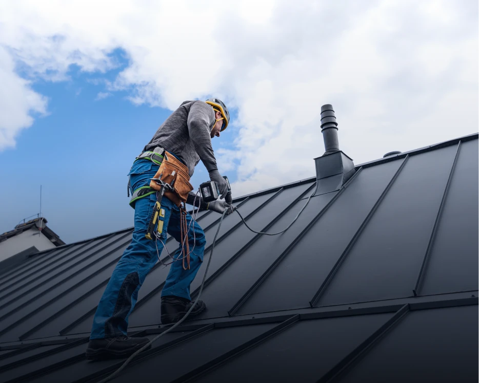 Roofer working on a metal roof.